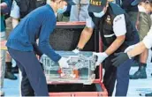  ?? DITA ALANGKARA AP ?? A box containing the f light data recorder is transferre­d after divers recovered it on Tuesday.