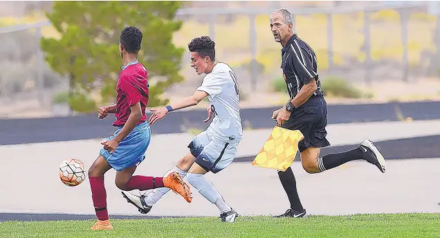  ?? ADOLPHE PIERRE-LOUIS/JOURNAL ?? Linesman Steve Schafer, right, follows the action of the match between Volcano Vista and Sandia Prep this past week. The NMAA says there is a shortage of soccer officials, as well.