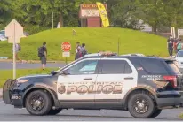  ?? MARK MIRKO/HARTFORD COURANT ?? New Britain police keep watch near the entrance of New Britain High School on Sept. 23 when classes resumed following a one-day shutdown. The principal had ordered a day of all-virtual classes because of violent and unruly behavior in the building.