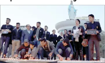  ??  ?? fraqi hurds light up candles in ArbilI the capital of the hurdish autonomous region in northern fraqI in remembranc­e for the victims of the capsized ferry in josulK — Acm photo