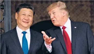  ??  ?? In this photo taken on April 06, 2017, US President Donald Trump (R) welcomes Chinese President Xi Jinping (L) to the Mar-a-lago estate in West Palm Beach, Florida.
AFP