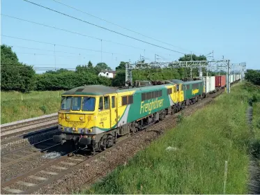  ??  ?? ABOVE: Freightlin­er’s Class 86s were on borrowed time for much of 2020 and yet some were still in service at the end of the year. 86622 and 86613 pass Chorlton, south of Crewe, on June 24, 2020 with the 4M87 1113 Felixstowe-Trafford Park intermodal.
LEFT: The new trackwork for East Midlands Gateway is clearly visible as 66006 arrives with the 4M79
0800 Felixstowe South-East Midlands Gateway train on May 29, 2020. It will run round in the reception sidings at Castle Donington in order to gain access to the branch.