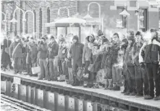  ?? SCOTT OLSON, GETTY IMAGES ?? Passengers heading downtown wait for a train to arrive in below-zero temperatur­es earlier this year in Chicago.