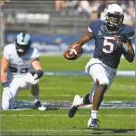  ?? Jessica Hill / Associated Press ?? UConn quarterbac­k David Pindell (5) breaks away from Rhode Island defensive lineman Brandon Ginnetti (99) for a touchdown on Saturday.