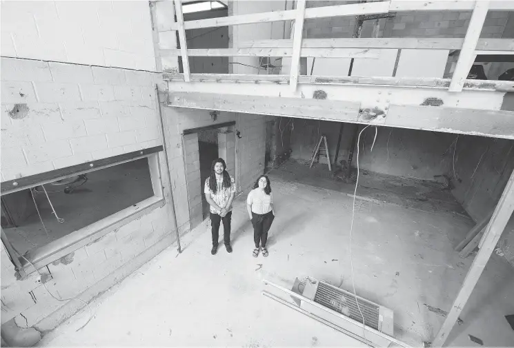  ?? QC PHOTO BY TROY FLEECE ?? Ishema Mwunvaneza, left, and Rochelle Berenyi, from Carmichael Outreach, stand in their new facility on 12th Avenue in Regina.