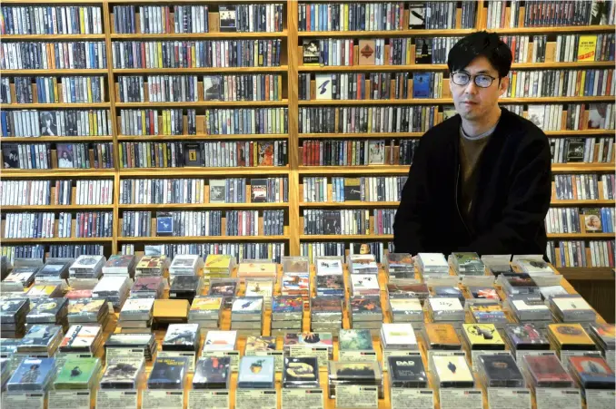  ?? Yomiuri Shimbun photos ?? Waltz owner Taro Tsunoda says he only plays cassettes at his music shop in Nakameguro, Tokyo.