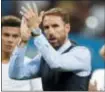  ?? REBECCA BLACKWELL — THE ASSOCIATED PRESS ?? England head coach Gareth Southgate applauds as he walks off the field at the end of a 2-1 semifinal loss to Croatia on Wednesday.