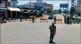  ?? PTI ?? Army personnel stand guard at a checkpoint near City Convention Centre area after three armed men were apprehende­d by a Mobile Vehicle Check Post (MVCP), in Imphal East district, on Monday