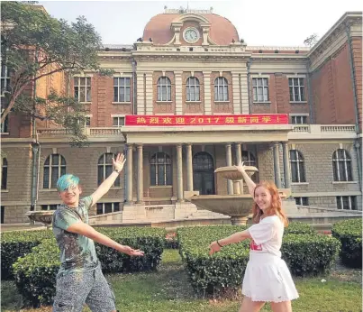  ??  ?? Kevin Shand and Alexandra Mccombie outside Tianjin Foreign Studies University in China.