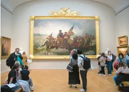  ?? TED SHAFFREY/AP ?? People wearing face masks view the Washington Crossing the Delaware painting at The Metropolit­an Museum of Art in New York City on Feb. 20.