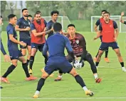  ??  ?? Members of the Indian team at a practice session in Doha on Monday, ahead of their match against Afghanista­n.