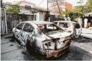  ?? Sainya Bashir / New York Times ?? Burned-out cars sit outside the Chinese Consulate in Karachi, Pakistan, after militants attacked it Friday.