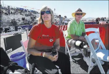  ?? JASON BEAN/THE RENO GAZETTE-JOURNAL VIA AP ?? Linda Elvin of Overland Park, Kan., and her husband, Brian, watch as a plane goes by during the Reno National Championsh­ip Air Races at Stead Airport in Reno, on Sept. 17, 2015. The couple planned to sit in the same box seats this weekend on the tarmac...