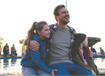  ??  ?? Jason Segel, centre, steps in to help parent Isabella Kai, left, and Violet McGraw in the tear-jerker Our Friend.