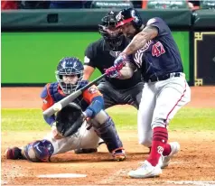  ?? Eric Gay/Associated Press ?? ■ Washington Nationals' Howie Kendrick hits a two-run home run against the Houston Astros during Game 7 of the World Series on Oct. 30, 2019, in Houston. To many National League fans, the scribble of “DH” on the lineup card sullies the whole stadium. To lots of American League fans, the sight of a pitcher touching a Louisville Slugger is a total affront to the diamond. No matter, that’s part of the proposal MLB owners are making to the players — a full-time designated hitter in the National League for this year only.