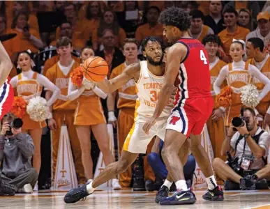  ?? AP FILE PHOTO/WADE PAYNE ?? Tennessee fifth-year senior guard Josiah-Jordan James, left, scored only one point in Saturday’s 91-71 home win over Alabama, but the Volunteers outscored the Crimson Tide by 20 points when he was on the floor.