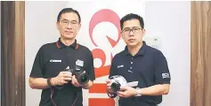  ??  ?? Ho (left) holds the EOS Canon 6D Mark II. With him is Canon Marketing (Malaysia) assistant manager Eric Tia, who is showing the EOS Canon 200D. — Photos by Tan Song Wei