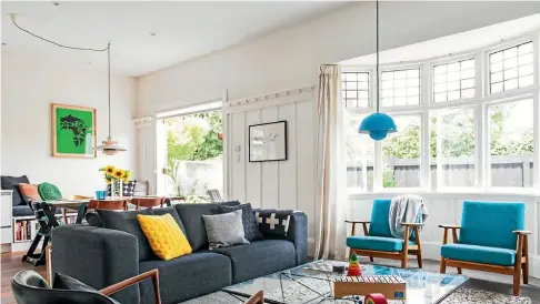  ?? PHOTO: KATE CLARIDGE ?? Christchur­ch designers Melanie Curragh and Jonathan Coote love mid-century furniture. Their living room features blue Hans Wegner chairs, a sofa from Heals in London and a black leather and rosewood Elizabeth chair designed by Ib-Kofod Larsen.