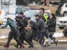  ?? Chet Strange / TNS ?? Shoppers are evacuated after a gunman opened fire at a supermarke­t in Boulder, Colo., on Monday.