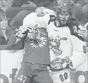  ?? Stuart Gradon, Calgary Herald ?? Roughnecks’ Peter Mcfetridge roughs up Knighthawk­s’ Jarrett Davis during Friday’s NLL game at the Saddledome.