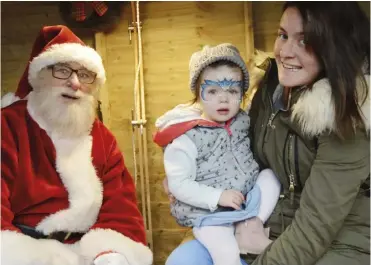  ?? Phil Creighton Pictures: ?? Harper (2) and Mum Natasha Kmiecik had a quiet word with Santa in his grotto at Dobbies Grovelands