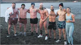  ?? Photograph: Iain Ferguson, The Write Image. ?? Dean Cameron (Santa hat) and some of his supporters spent four minutes inthe loch ‘soaking in’ the cold to raise awareness of an money for mental health charities.