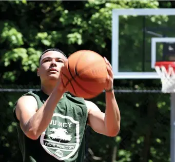  ?? NAncy lAnE / HErAld stAFF ?? HORSE SENSE: Dylan Richardson, a park monitor for Quincy Parks and Recreation, lines up a shot at the reopened Merrymount Park court Tuesday in Quincy.