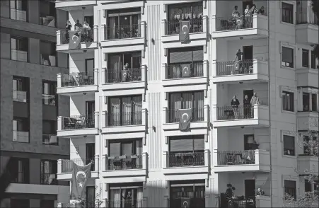  ?? YASIN AKGUL / AFP ?? National flags are draped from balconies in Istanbul, Turkey, on April 23 to mark National Sovereignt­y and Children’s Day, with the country under lockdown to stop the spread of COVID-19.