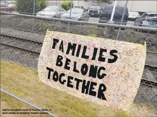  ??  ?? Sign at detention center in Tacoma, Wash., is stark rebuke to President Trump’s policies.