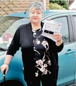  ??  ?? Parking mad Anne Shields stands with her parking fine that cost her over £161