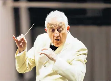  ?? Photograph­s by Maria Alejandra Cardona Los Angeles Times ?? BRAMWELL TOVEY conducts a “Carmina Burana” performanc­e Tuesday; the program repeats Thursday.