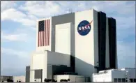  ?? Bloomberg News/ANDREW HARRER ?? The NASA logo and U.S. flag mark the Vehicle Assembly Building at NASA Kennedy Space Center in Cape Canaveral, Fla. The 526-foot-tall structure is on NASA’s list to sell or lease.