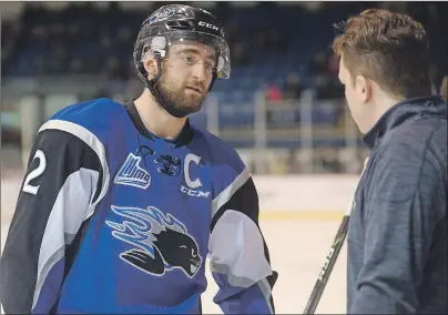  ?? JASON MALLOY/THE GUARDIAN ?? Saint John Sea Dogs defenceman Bailey Webster, left, speaks with equipment manager Tyler Jay before a game in Charlottet­own on March 17. Webster wore the captain’s C for the contest.