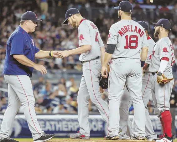  ?? USA TODAY PHOTO ?? HIT THE SHOWERS: Red Sox manager John Farrell (left) takes the ball from ace Chris Sale in the fifth inning of last night’s series finale in New York. Sale allowed three runs and fell to 15-7 as the Sox lost to the Yankees, 9-2, and saw their AL East...