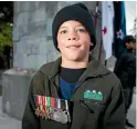  ??  ?? Alex Ward, 7, is wearing his great-grandfathe­r’s World War II medals.