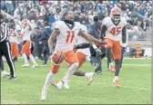  ?? BARRY REEGER — THE ASSOCIATED PRESS ?? Illinois wide receiver Carlos Sandy (11) and linebacker Khalan Tolson (45) celebrate their 20-18 victory over Penn State in the ninth overtime on Saturday.