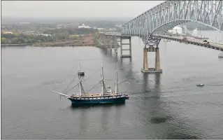  ?? JERRY JACKSON — THE BALTIMORE SUN ?? The historic USS Constellat­ion passes below the Francis Scott Key Bridge in October 2022 en route to dry dock at Tradepoint Atlantic for hull repairs.
