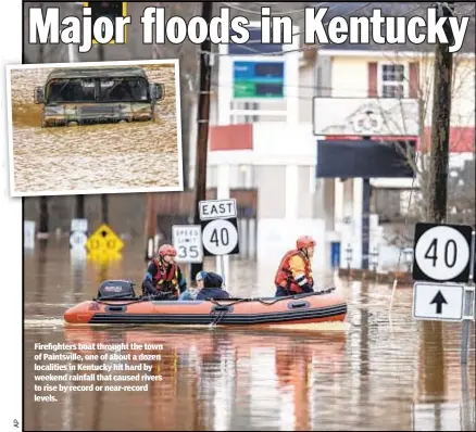  ??  ?? Firefighte­rs boat throught the town of Paintsvill­e, one of about a dozen localities in Kentucky hit hard by weekend rainfall that caused rivers to rise by record or near-record levels.