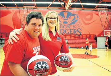  ?? ALLAN BENNER/POSTMEDIA NEWS ?? Gregory McPherson, left, with Brock women's basketball team head coach Ashley MacSporran, launching a week-long compassion­ate city basketball camp at the university, on Monday.