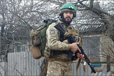  ?? CHECHO - VIA THE ASSOCIATED PRESS ?? A profession­al soldier from Medell’n, Colombia, who goes by the call sign Checho, in his combat gear in Donbas, eastern Ukraine, in 2023. Checho says he was struck by fire from a drone during a rescue operation.