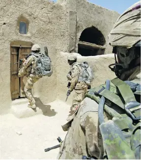  ?? MCPL ROBERT BOTTRILL / CANADIAN FORCES COMBAT CAMERA ?? Canadian Forces soldiers enter a compound in Zjarey district, searching for evidence of Taliban activity in a joint Afghan National Army and coalition security operation.