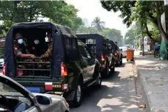  ??  ?? Three of the vehicles in the military convoy that escorted journalist­s on the first day of the tour in Yangon (The Washington Post/Allegra Mendelson)