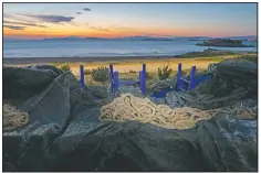  ??  ?? A rope used for decoration is placed on a canvas covering tables and chairs of a shuttered fish restaurant at the seaside suburb of Kavouri, a district of Athens.