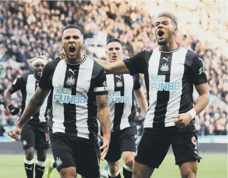  ??  ?? Jamaal Lascelles (left) celebrates scoring Newcastle United’s goal against Wolves, with Joelinton.