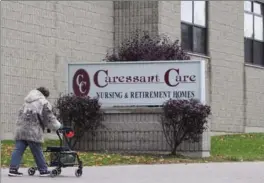  ?? DAVE CHIDLEY, THE CANADIAN PRESS FILE PHOTO ?? A woman walks into the Caressant Care facility in Woodstock where a former nurse is accused of killing seven seniors. On Jan. 25, the nursing home was ordered to stop admitting patients.