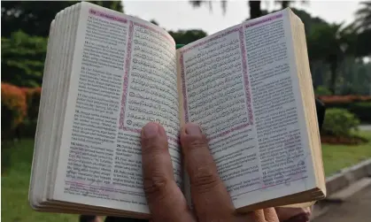  ?? Photograph: Adek Berry/AFP/Getty Images ?? A demonstrat­or holds a copy of the Qur’an with accompanyi­ng translatio­n during a rally in Jakarta on 2 July, as Salwan Momika’s actions continue to outrage Muslims worldwide.