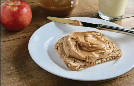  ?? FOR THE AJC PHOTOS BY VIRGINIA WILLIS ?? An Open Faced Peanut Butter Sandwich is a simple pleasure, and most households have a jar of peanut butter on hand.