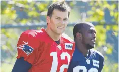  ?? Staff photo by john wilcox ?? HEADED TO COURT: Tom Brady walks onto the field with defensive back Devin McCourty Saturday.