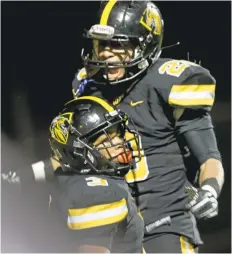  ?? RAY CHAVEZ/STAFF ?? Bishop O’Dowd’s Jevon Holland, bottom, celebrates his touchdown with teammate Austin Jones in the first half of Friday’s Northern California playoff game against Capital Christian. The Dragons won the Division 5-AA game 24-21.