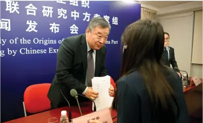  ?? (Thomas Suen/Reuters) ?? LIANG WANNIAN, co-leader of the WHO-China joint expert team, listens to a reporter’s question at the end of a news conference in Beijing, last month.